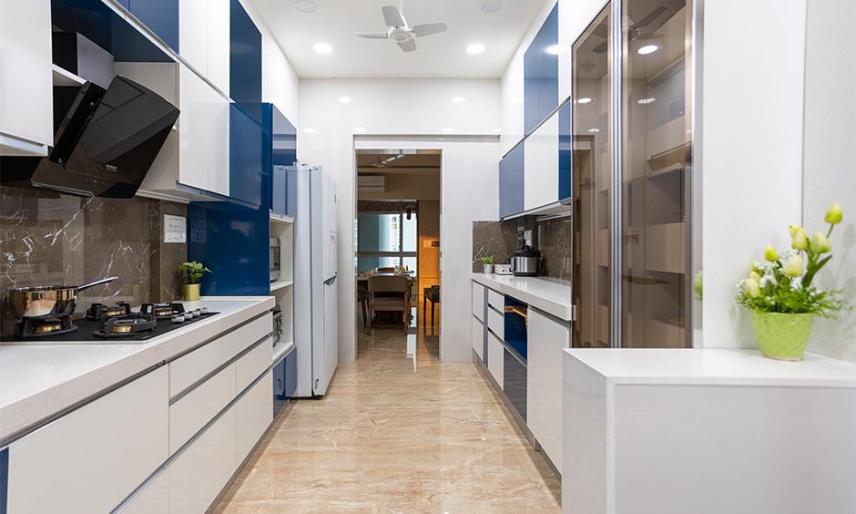 HDB wet and dry kitchen with sliding glass partition, vertical storage, and compact moisture-resistant materials.
