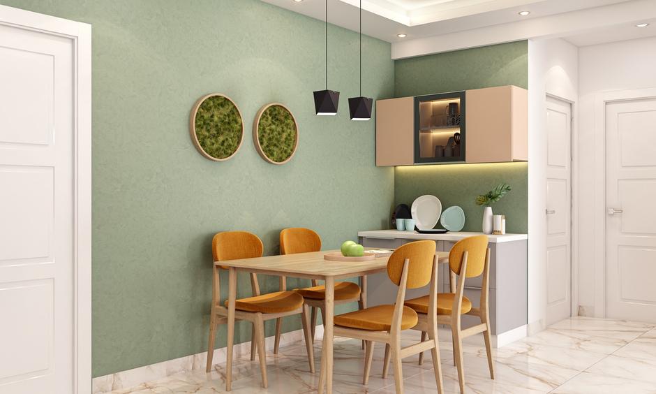 Dining room paint ideas using soft sage green walls for a calm, airy feel with a natural touch.