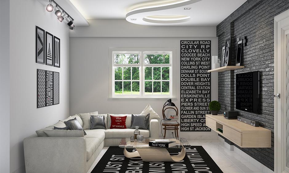 Quirky black and white living room with brick wall, rug, and creative accents